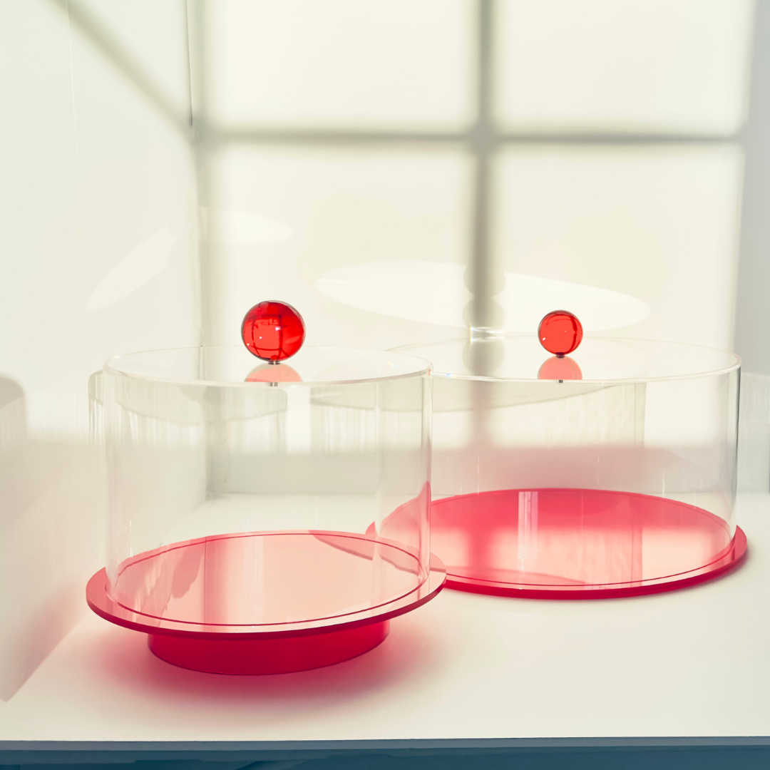 Tara Pastry Tray - britt elizabeth 2 red and clear acrylic cake stands on a white table with a white background