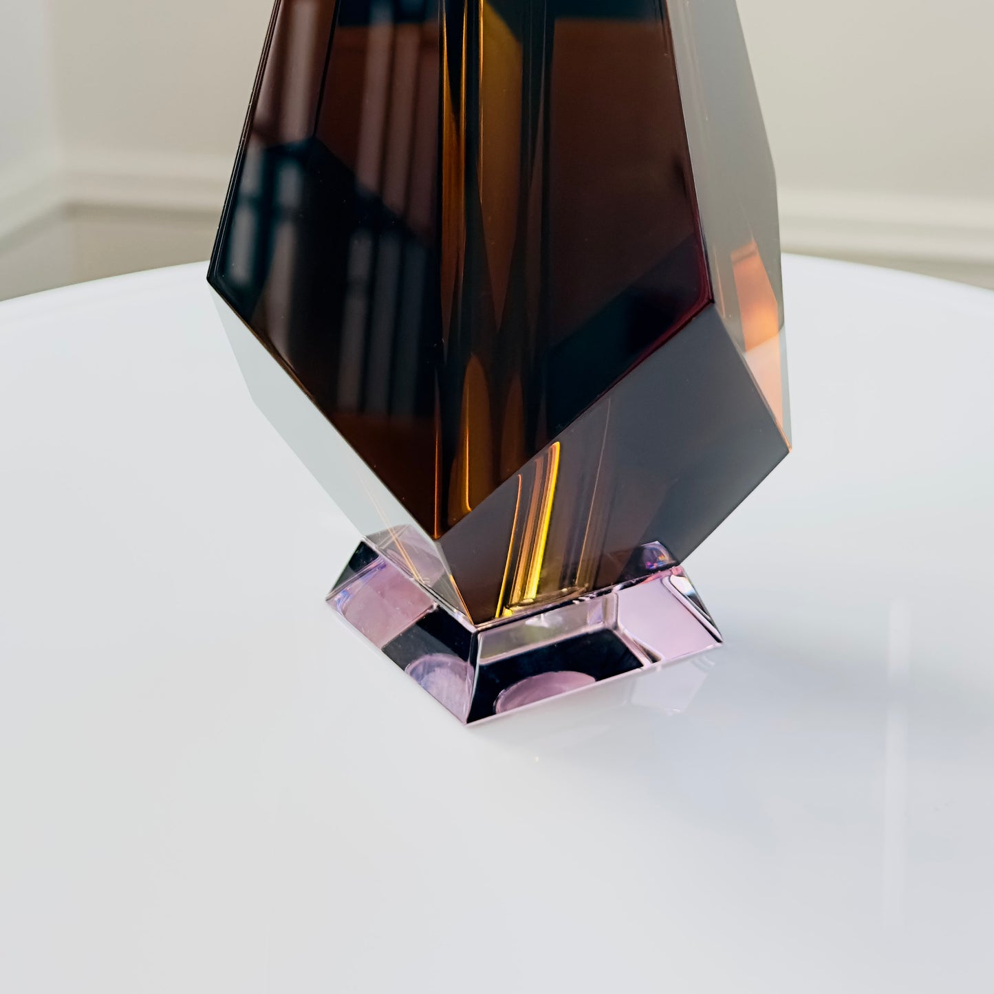 Decorative glass vase with geometric design on a white surface