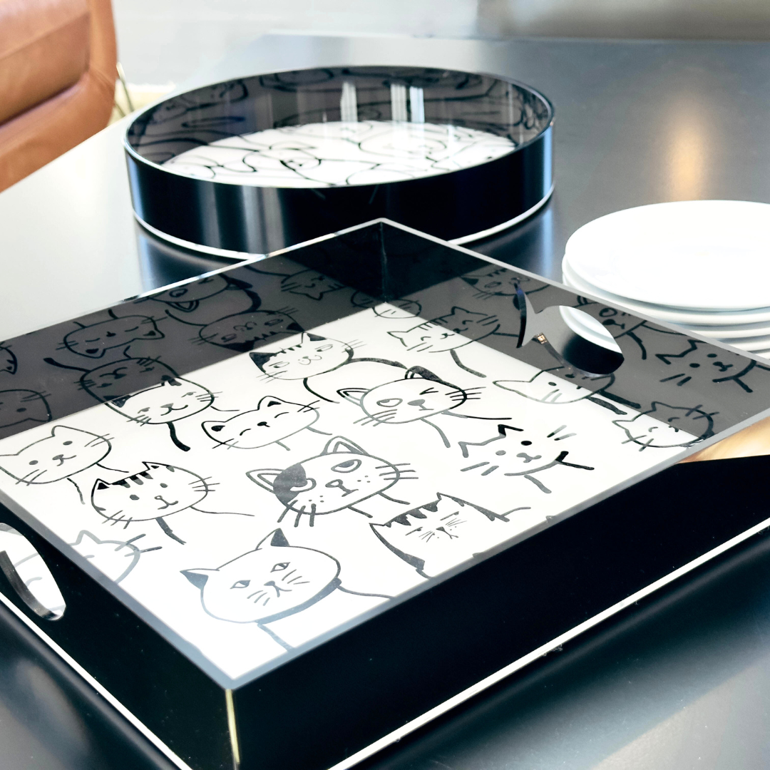Maybee - Square Serving Tray - britt elizabeth 1 round black tray and 1 square black tray on a black surface