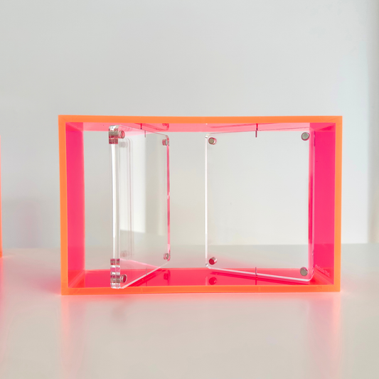 Clear and pink acrylic photo frame with neon pink border on a white background