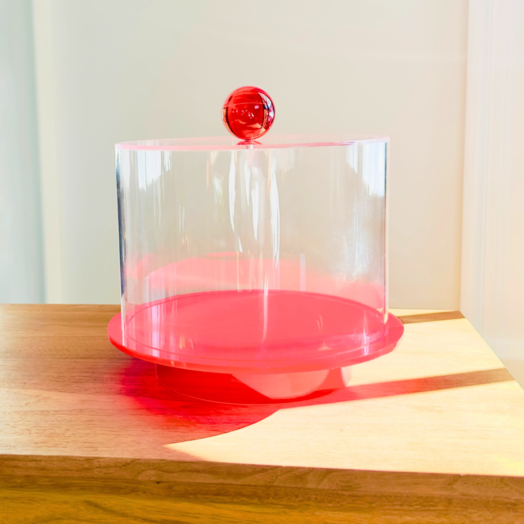 Tara Pastry Tray - britt elizabeth cealr acrylic cake tray with red ball handle on a wooden table
