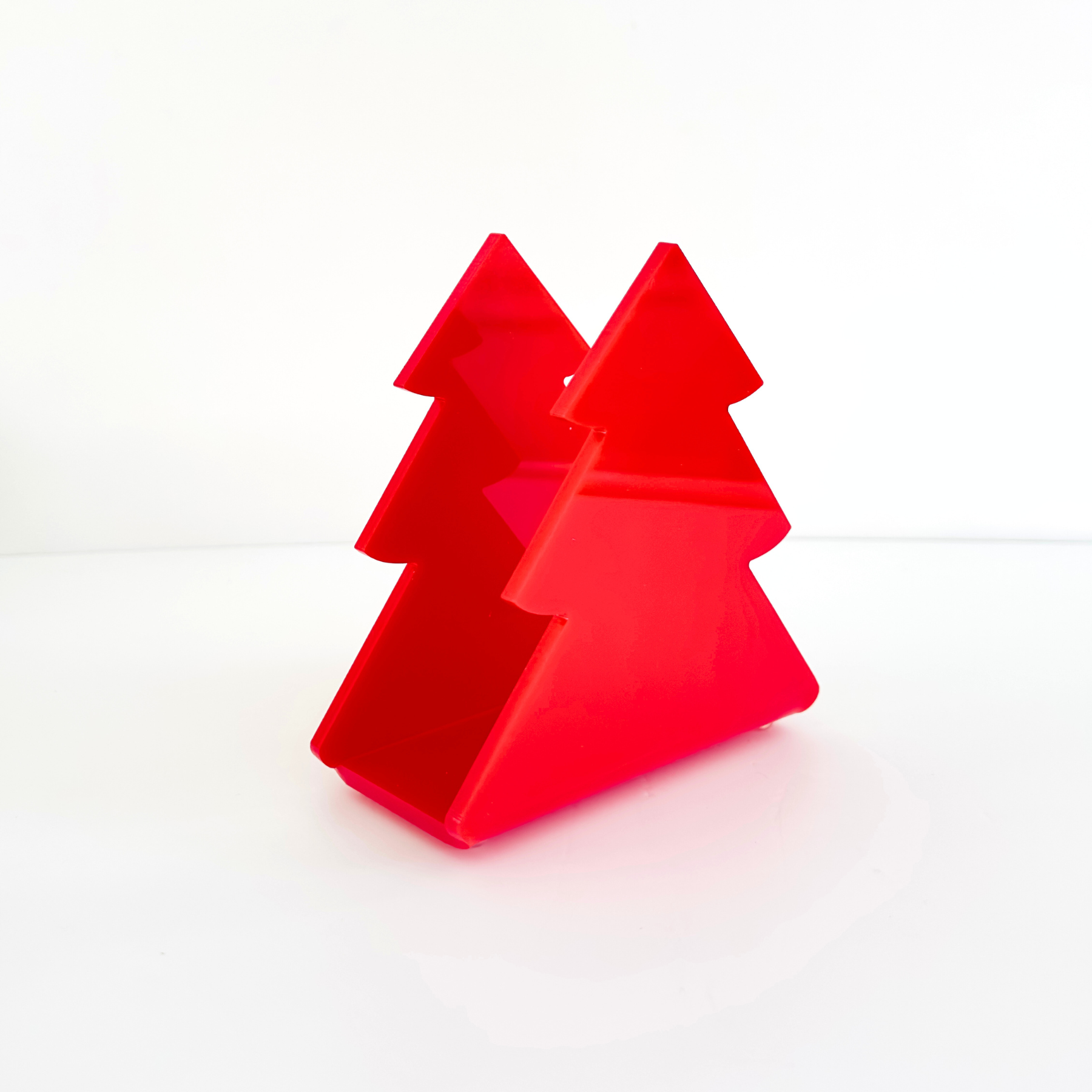 Acrylic red Christmas tree-shaped object on a white background