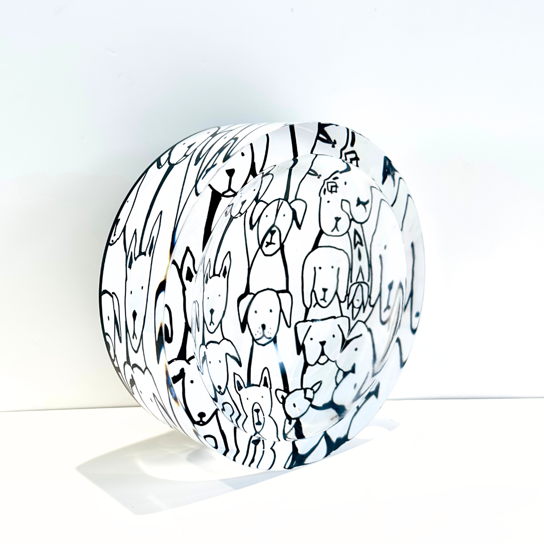 Round  bowl object with black line art of dogs on a white background