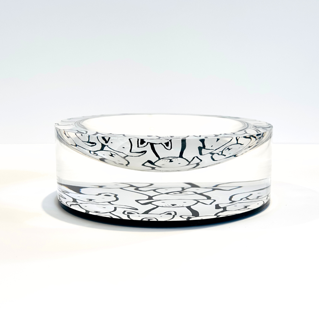 Decorative acrylic bowl with black and white god faces patterns on a white background