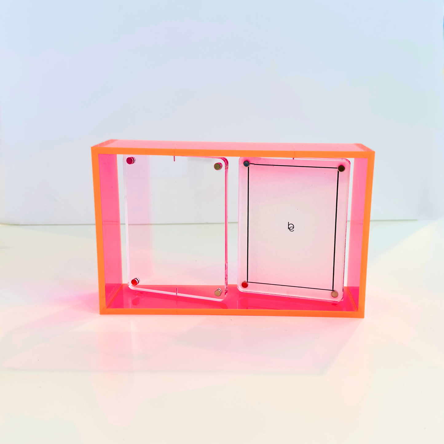 Clear and pink acrylic frame with pink on a white background