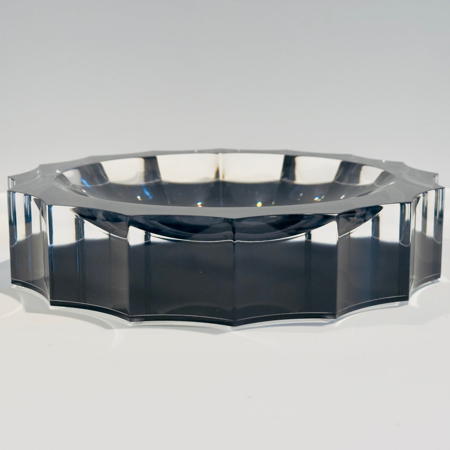 Octagonal black bowl on a white background