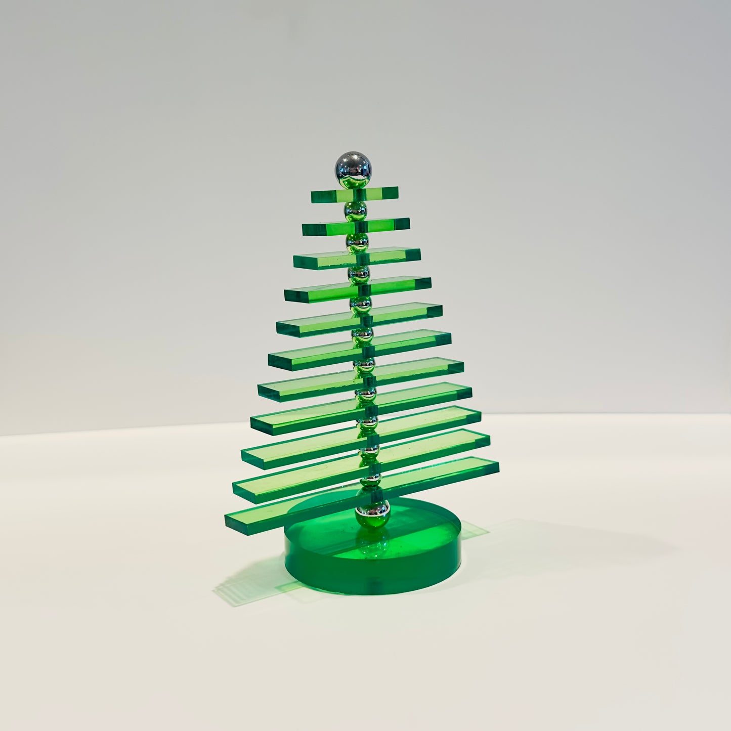 Green acrylic Christmas tree on a white background
