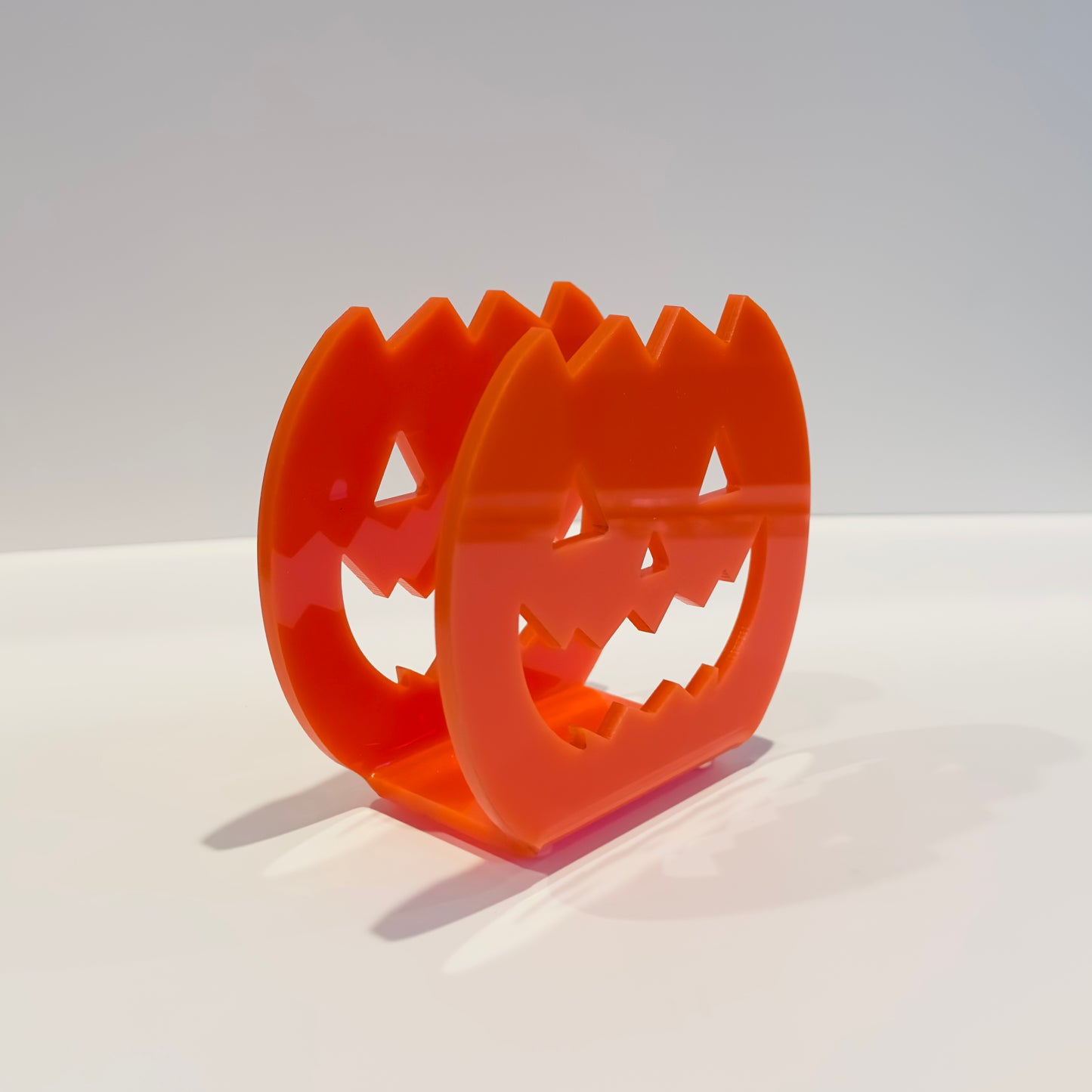 Orange jack-o'-lantern faces on a white background