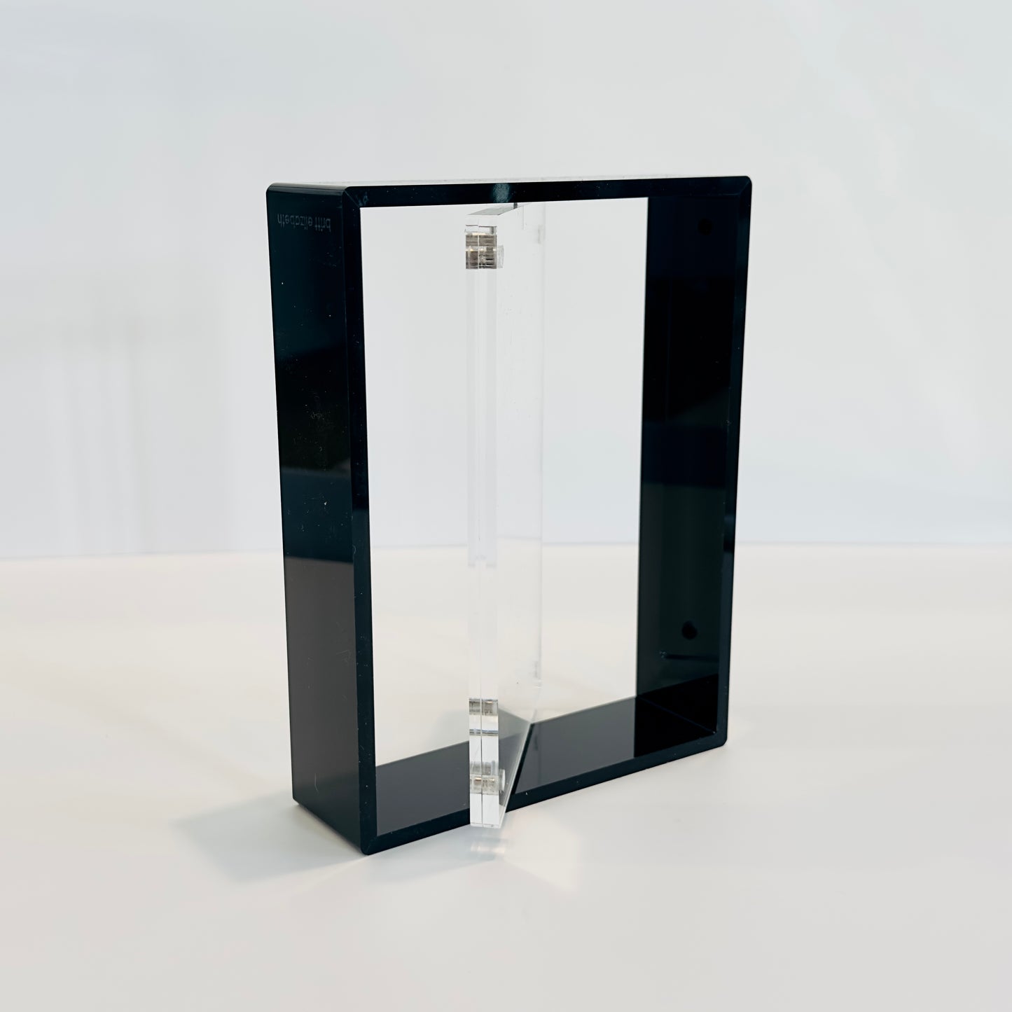 Black rectangular frame with a clear glass panel on a white background