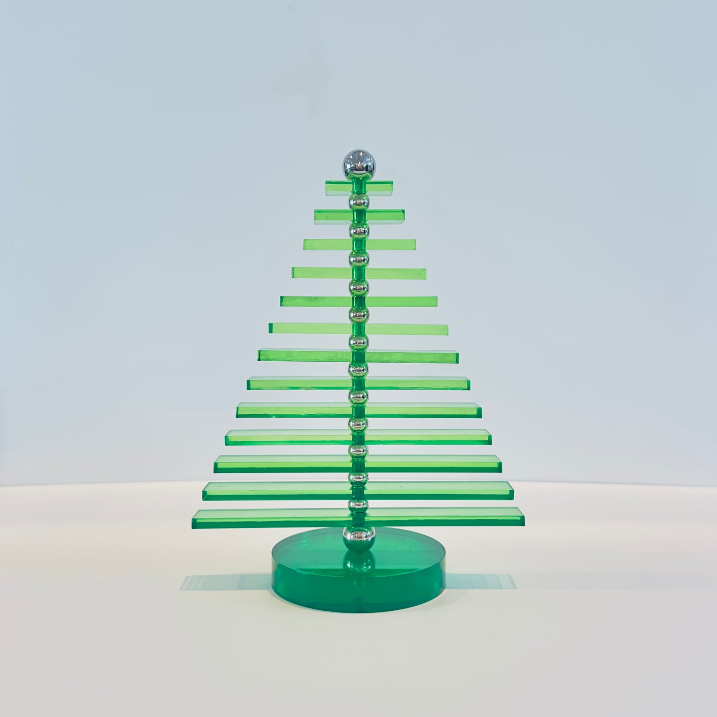 Green acrylic Christmas tree on a white background