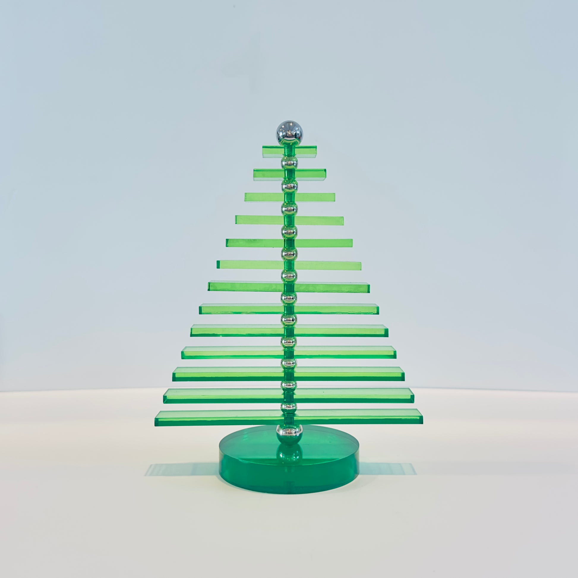 Green acrylic Christmas tree on a white background
