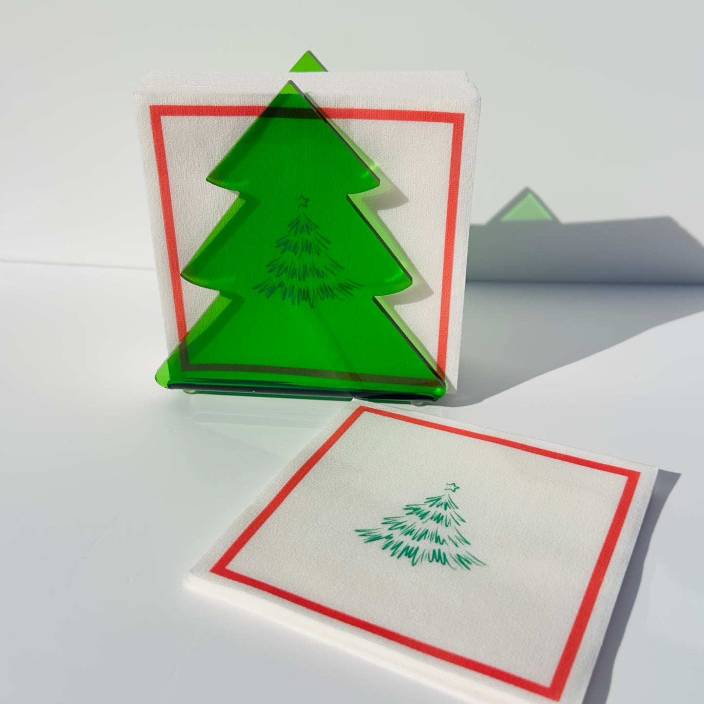 Green Christmas tree design on a white background with napkins on the table