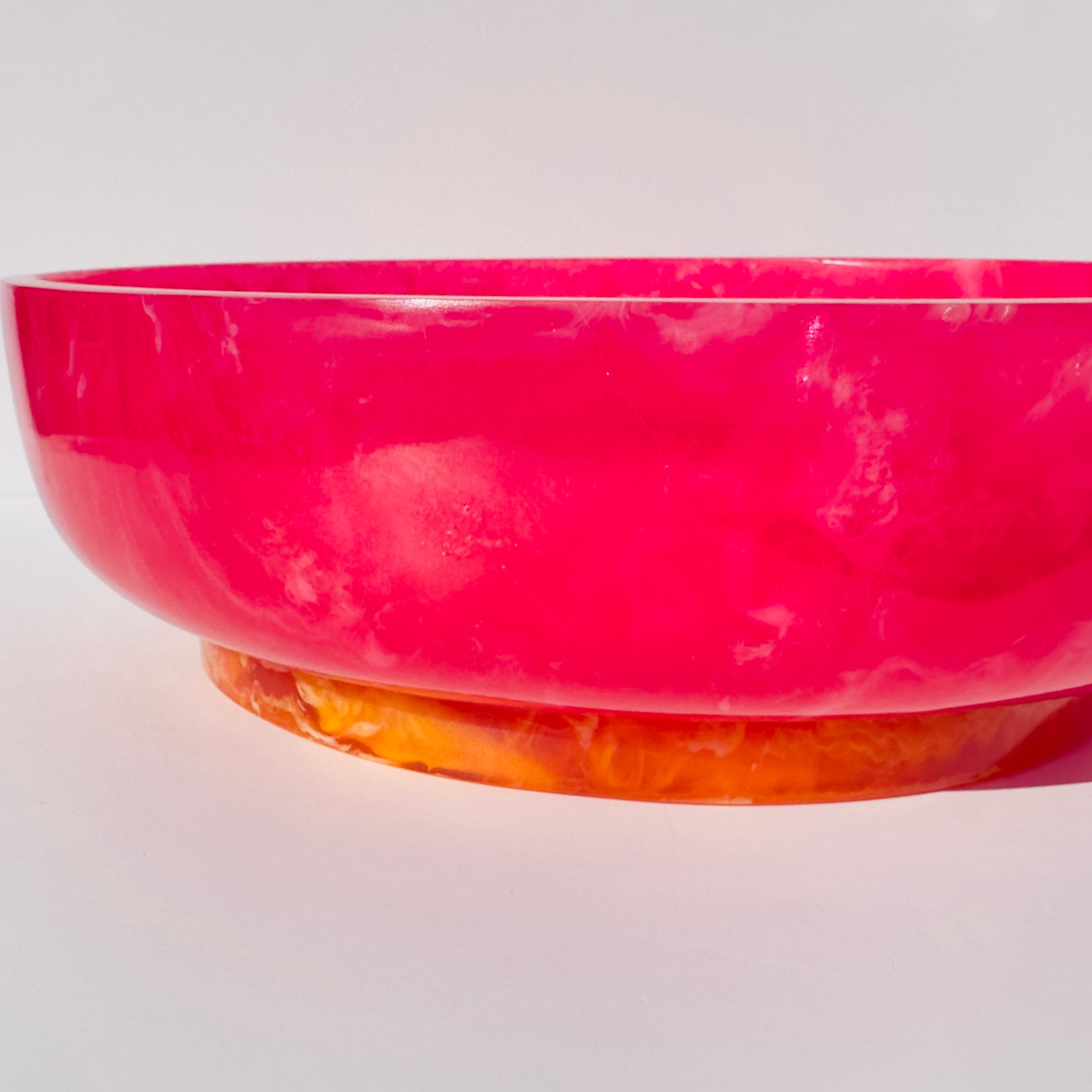 Pink and orange marbled bowl on a white background
