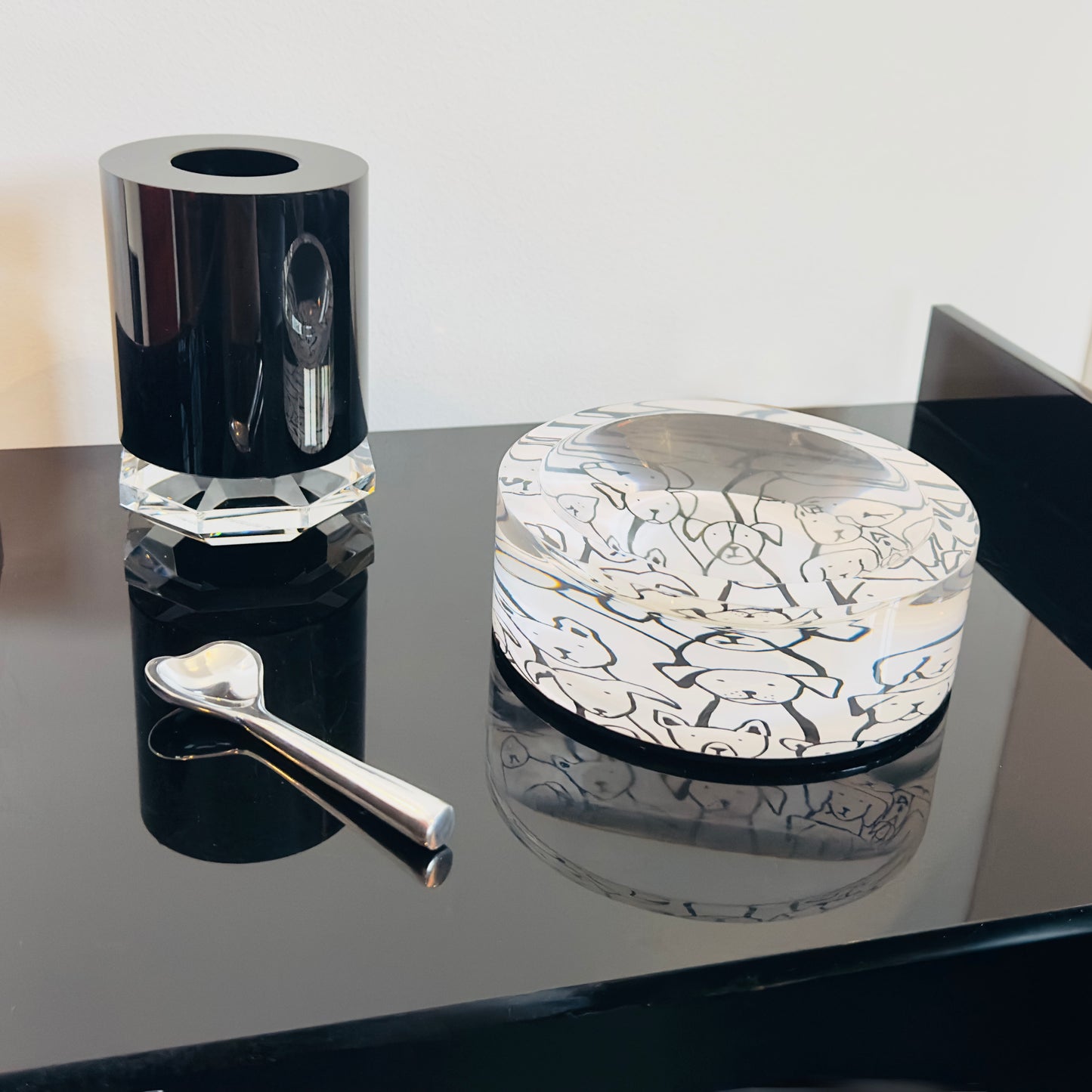 Decorative glass pieces on a reflective surface with a neutral background