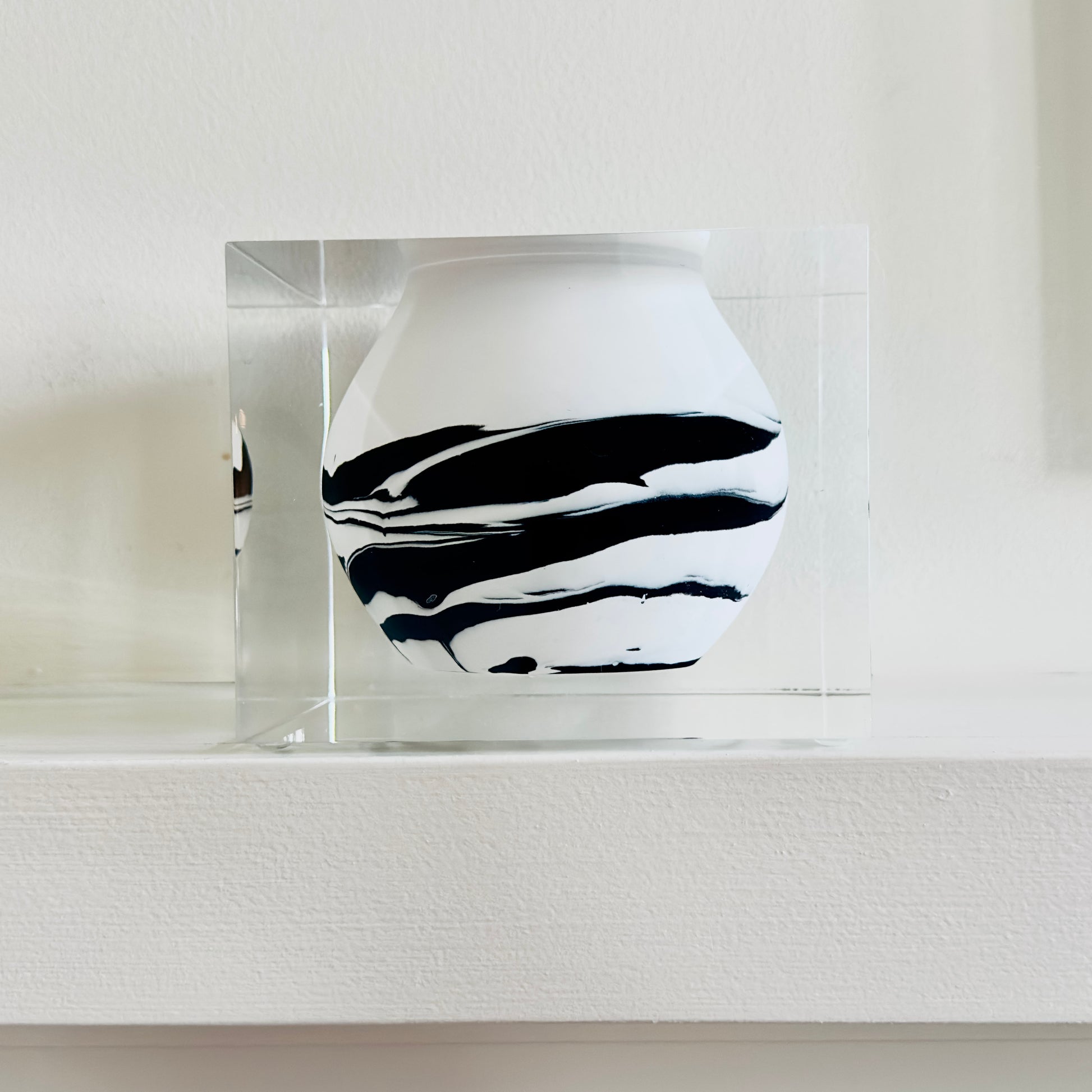 White vase with black abstract patterns on a white background